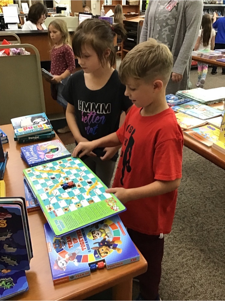Students looking at books for sale.