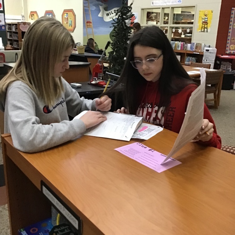 Students working on a clue in the library.