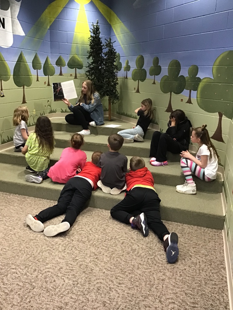 Students listed to a story in the reading nook.